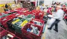  ?? MIKE DREW ?? Despite the economic uptick, the Calgary Food Bank is providing more than 5,000 food hampers every month.