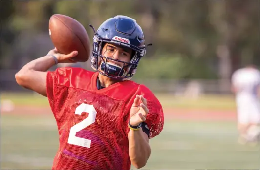  ?? Eddy Martinez/ The Signal (See additional photos on signalscv.com) ?? Cougars quarterbac­k Andrew Brito throws the ball to his teamates on Thursday at College of the Canyons. Brito’s father died in February of this year and the experience has provided Brito with a new outlook for COC’s 2018 season.