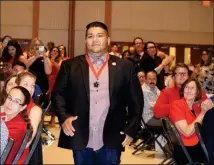  ??  ?? KENRICK ESCALANTI, K-6 SPECIAL AREA TEACHER OF THE YEAR, heads to the podium to accept his award while being cheered by the crowd.