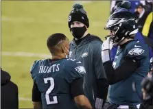  ?? DERIK HAMILTON — THE ASSOCIATED PRESS ?? Philadelph­ia Eagles’ Jalen Hurts, from left, Carson Wentz and Nate Sudfeld talk during the second half of an NFL football game against the Washington Football Team, Sunday, Jan. 3, 2021, in Philadelph­ia.