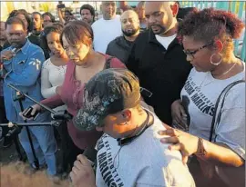  ?? Genaro Molina
Los Angeles Times ?? DENISE HARLINS, center, at a vigil this week for niece Latasha Harlins, whose death 25 years ago led to the creation of the Latasha Harlins Justice Committee.