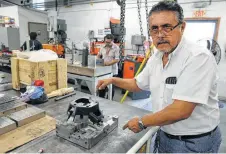  ?? Bob Owen / Staff photograph­er ?? Julio Guerrero, ower of Alpha XL Mold and Tool in Mission, explains the mold-making process for casting a plastic auto part.