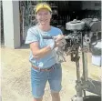  ?? Picture: SUPPLIED ?? POWERFUL: Niki Cunningham with her husband’s Seagull outboard motor.