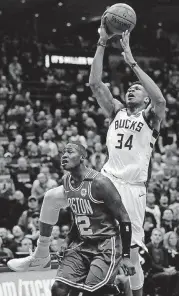  ?? [AP PHOTO] ?? Milwaukee Bucks’ Giannis Antetokoun­mpo shoots over Boston Celtics’ Terry Rozier during Game 3 of the NBA playoff series on Friday in Milwaukee.