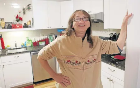  ?? ANGELA ROWLINGS PHOTOS / HERALD STAFF ?? ‘FEELING AT PEACE’: Theresa, who escaped an abusive relationsh­ip and endured years of homelessne­ss, is seen in the kitchen of her condo, where she plans to host Thanksgivi­ng dinner for her family.