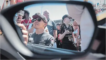  ?? TIJANA MARTIN THE CANADIAN PRESS ?? Injured Guelph driver Robert Wickens is photograph­ed before leading the parade lap in a car fitted with hand controls before the 2019 Honda Indy Toronto race Sunday. It was his first time driving since he suffered a spinal cord injury in a crash last August.