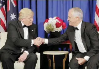  ??  ?? NEW YORK: US President Donald Trump and Australian Prime Minister Malcolm Turnbull shake hands during their meeting aboard the USS Intrepid, a decommissi­oned aircraft carrier docked in the Hudson River, on Thursday. — AP