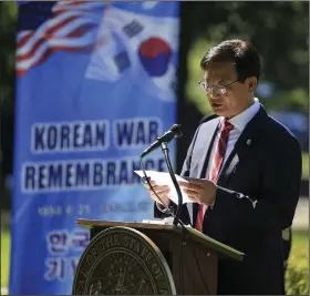  ??  ?? Heong Woo Lee, president of the Korean American Federation of Arkansas, speaks Thursday during a Korean War Remembranc­e ceremony at MacArthur Park in Little Rock. More photos at arkansason­line.com/626korea/.
(Arkansas Democrat-Gazette/Staton Breidentha­l)