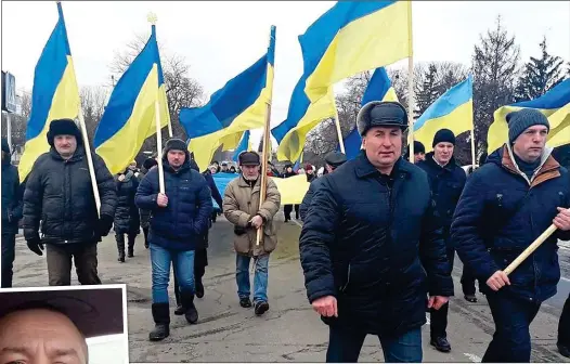  ?? ?? RESISTANCE: The people of occupied Horodnya parade their flag. Left: Roman Makas chose death over Russia