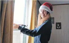  ??  ?? Thermo Homes air sealing supervisor Meghan Somerville applies caulking around the windows of Mary McNutt’s home in Steam Mill.