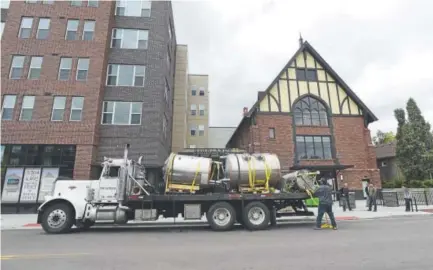  ?? Jeremy Papasso, Daily Camera ?? Crews bring brewing equipment inside the new Oasis Brewing location — the former Beth Eden Baptist Church on Lowell Boulevard in Denver.