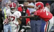  ?? JOHN BAZEMORE — THE ASSOCIATED PRESS ?? Georgia defensive back Richard LeCounte (2) tries to tackle Alabama wide receiver Jaylen Waddle (17).