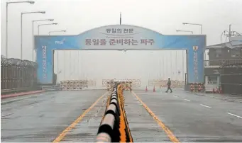  ?? AP ?? A South Korean army soldier walks on Unificatio­n Bridge, which leads to the demilitari­sed zone, near the border village of Panmunjom in Paju, South Korea, yesterday. North Korea yesterday cancelled a high-level meeting with South Korea.