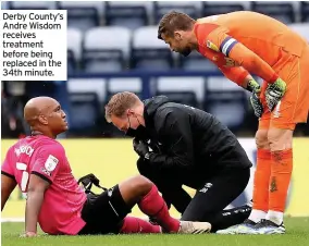  ??  ?? Derby County’s Andre Wisdom receives treatment before being replaced in the 34th minute.