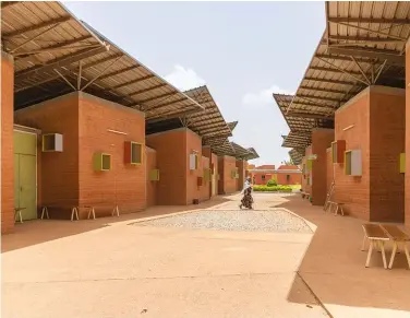  ??  ?? ABOVE: Also in Burkina Faso, Kéré’s Léo Surgical Clinic & Health Center is an ensemble of modules arranged around a central outdoor corridor. The setup allows for a variety of sheltered interstiti­al spaces that feel both dynamic and welcoming.