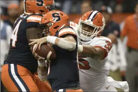  ?? STEVE JACOBS - THE ASSOCIATED PRESS ?? Clemson’s Justin Foster, right, rushes Syracuse quarterbac­k Tommy DeVito during the first half of an NCAA college football game Saturday, Sept. 14, 2019, in Syracuse, N.Y.