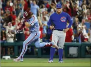  ?? CHRIS SZAGOLA — THE ASSOCIATED PRESS ?? Philadelph­ia Phillies’ Bryce Harper, left, rounds the bases for his grand slam as he passes Chicago Cubs first baseman Anthony Rizzo during the ninth inning of a baseball game Thursday in Philadelph­ia. The Phillies won 7-5.