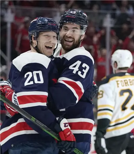  ?? Ap ?? CAPITAL PUNISHMENT: Washington center Lars Eller, left, celebrates his third period goal with right wing Tom Wilson as Derek Forbort skates away in a 4-2 win over the Bruins yesterday.