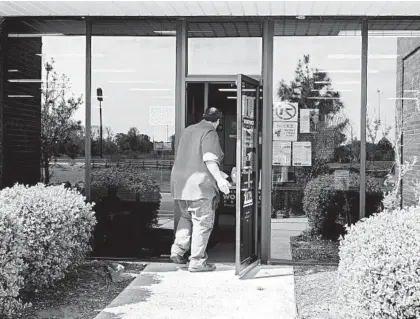  ?? HOUSTON COFIELD/THE NEW YORK TIMES ?? A man enters an unemployme­nt office April 9 in Forest City, Arkansas, as states scramble to deal with a deluge of claims.