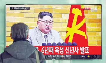  ??  ?? A man watches a television news broadcast showing Kim’s New Year’s speech at a railway station in Seoul. — AFP photo