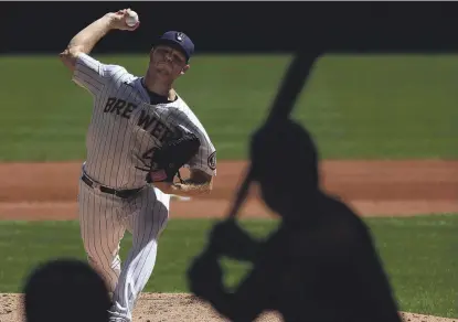  ?? GETTY IMAGES ?? Brewers right-hander Brandon Woodruff allowed four hits, four runs and three walks with seven strikeouts in five innings during the loss to the Pirates on Sunday afternoon.