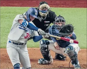  ?? Robert Gauthier Los Angeles Times ?? JOC PEDERSON homers in the second inning, taking the Dodgers’ lead to 3- 0 in Game 5 at Globe Life Field. The Boys in Blue are a victory away from winning the World Series for the f irst time since 1988.