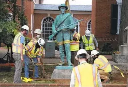  ?? ERIN EDGERTON AP ?? A bronze statue of an unnamed Confederat­e soldier, titled “At Ready,” is removed from the Albemarle County Circuit Courthouse in Charlottes­ville, Va.