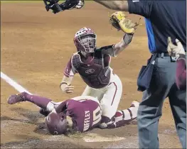  ?? SUE OGROCKI — THE ASSOCIATED PRESS ?? Oklahoma catcher Lynnsie Elam, right, shows the ball to the home plate umpire, who called Florida State’s Josie Muffley safe due to obstructio­n in the seventh inning.