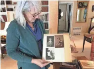  ?? MEG JONES/MILWAUKEE JOURNAL SENTINEL ?? Elizabeth Goessling looks at photos of her grandmothe­r, Hildegarde Van Brunt Abbott, who served as a telephone operator in France during World War I with the U.S. Army Signal Corps.