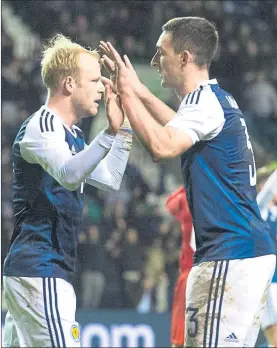  ??  ?? GLIMMER OF HOPE: Lee Wallace hails Steven Naismith after his equaliser