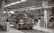  ?? Ryan Garza/Detroit Free Press/TNS ?? A GMC Denali HD pulls out for final testing at the General Assembly building at General Motors Flint Assembly in Flint.