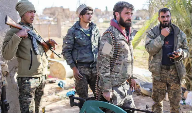  ?? Agence France-presse ?? Fighters with the SDF check a makeshift camp for Daesh group members in the town of Baghouz, Deir Ezzor, Syria.