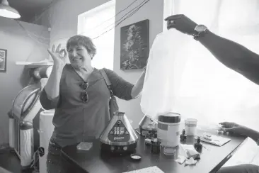  ?? Photos by Santiago Mejia / The Chronicle ?? Jane Todd of Lafayette reacts after smoking pot from a vaporizer during the East Bay Senior Cannabis Social Club meeting at the Magnolia Dispensary in Oakland. Below, Michael Grafton takes a hit.