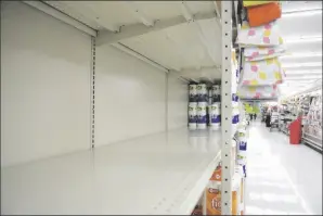  ?? LINDSEY SHUEY/REPUBLICAN-HERALD VIA AP ?? IN THIS NOV. 2 FILE PHOTO, a section of shelving that normally holds paper towels sits empty at Redner’s in Schuylkill Haven, Pa., amid the latest surge of the coronaviru­s pandemic.