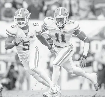  ?? JOSHUA C. CRUEY/ORLANDO SENTINEL ?? Florida linebacker Neiron Ball (11) runs for yardage after intercepti­ng a pass against Georgia in 2012. Ball has been having serious health problems due to a brain aneurysm that has left him paralyzed in all four limbs.