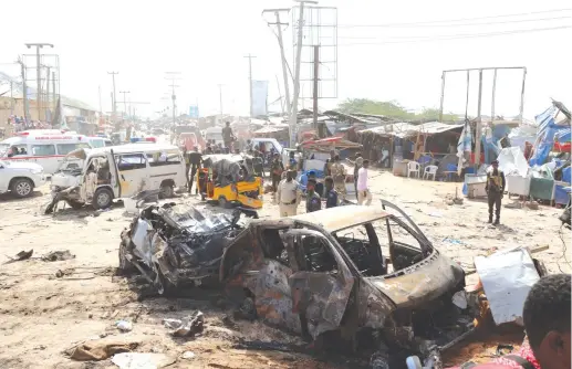  ?? (Reuters) ?? THE SCENE of a car bomb explosion at a checkpoint in Mogadishu, Somalia, yesterday.