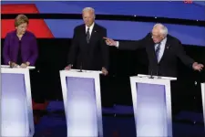  ?? PATRICK SEMANSKY / AP ?? Democratic presidenti­al candidate Sen. Bernie Sanders, I-Vt., right, speaks to Sen. Elizabeth Warren, D-Mass., left, as former Vice President Joe Biden listens Tuesday, Jan. 14, 2020, during a Democratic presidenti­al primary debate hosted by CNN and the Des Moines Register in Des Moines, Iowa.