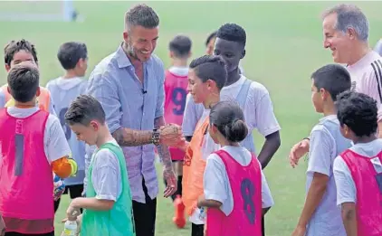  ?? JOHN MCCALL/SUN SENTINEL ?? David Beckham shakes hands with players from Inter Miami’s academy teams at Central Broward Regional Park Stadium in Lauderhill.