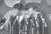  ?? THE ASSOCIATED PRESS PHOTO ?? The Beatles address the media in the press room of Kennedy Internatio­nal Airport on their arrival, Feb. 7, 1964 in New York.