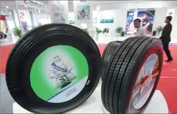  ?? WU CHANGQING / FOR CHINA DAILY ?? Michelin’s tires are displayed at an auto parts show in Beijing.