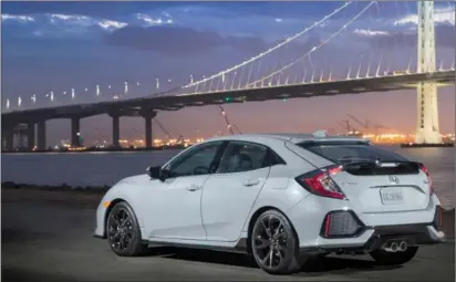  ??  ?? The dual centre exhaust tips hint at greater performanc­e than there actually is, but they will be right at home on the 300-plus horsepower­Type-R.Below:The dash is clean and well laid out.