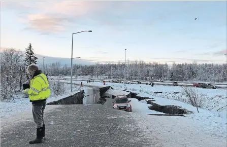  ?? DAN JOLING THE ASSOCIATED PRESS ?? A car is trapped on a collapsed section of Minnesota Drive in Anchorage on Friday after Alaska was struck by back-to-back earthquake­s.