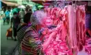  ?? Photograph: Alex Plavevski/EPA ?? A woman smells the meat before buying at Xihua market in Guangzhou. The shortage of pork after the outbreak of ASF increased demand for other meat in China.