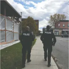  ?? SHaaMINI YOGARETNAM ?? Sgt. Wayne Stangle and Sgt. Andrew Pidcock walk the beat as city police launch new neighbourh­ood response teams.