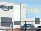  ?? JAY REEVES/AP ?? A banner encouragin­g workers to vote in labor balloting hangs at an Amazon warehouse in March in Bessemer, Alabama.