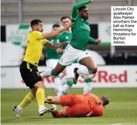  ??  ?? Lincoln City goalkeeper Alex Palmer smothers the ball as Kane Hemmings threatens for Burton Albion.