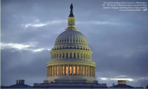  ?? — AFP ?? US Capitol building before sunrise in Washington, DC. The House of Representa­tives overwhelmi­ngly passed a stopgap spending bill on Friday averting a government shutdown.