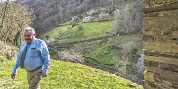  ??  ?? Pepe Rodil, a manager at an estate sales agency, walks in front of Teixois hamlet in the Asturias region of Spain. – Bloomberg photos by Angel Navarrete