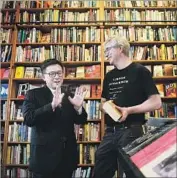  ?? Christina House For The Times ?? JOHN CHIANG, left, visits with David Kipen at his Boyle Heights lending library, Libros Schmibros.