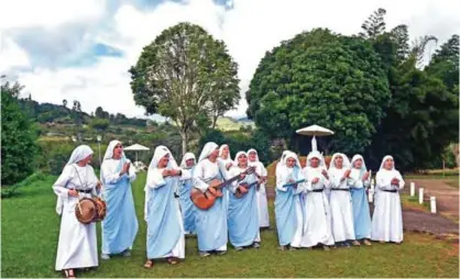  ??  ?? Fellow nuns of Maria Valentina de los Angeles, of the ‘Comunicado­ras Eucaristic­as del Padre Celestial’ (Eucharisti­c Communicat­ors of the Celestial Father) congregati­on, perform during the recording of a music video at a convent on the outskirts of...